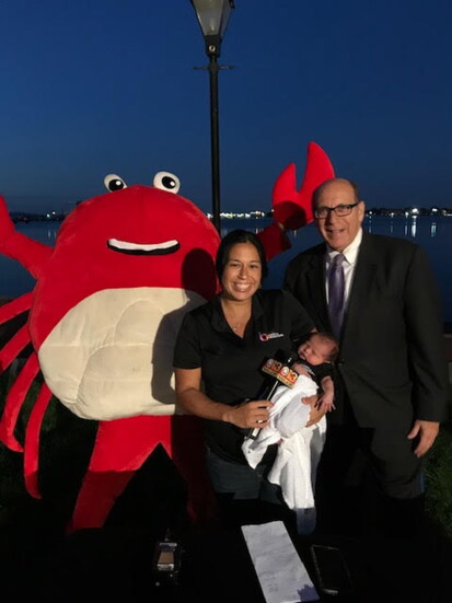 Beth Laverick doing a TV spot with WJZ-TV with her son Brandt and Dave Minnon (as the crab).
