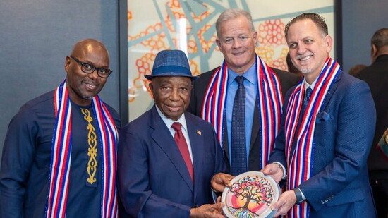 Steven Franco, Mark Romney and Zhalman Harris present a gift to Liberia’s President, advancing global collaboration in agriculture, food security, productivity.