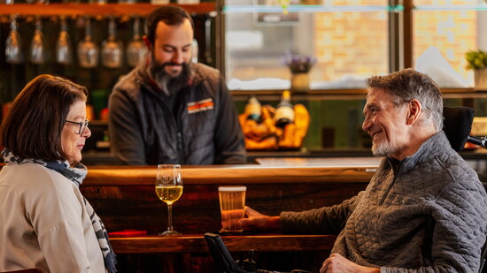 Weidman and Hanson relax at Buckley's Market and Cafe's accessible bar counter. Photo by Kevin Edge
