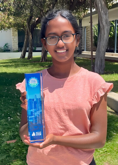 Akshitha Vinodh of Parras Middle School poses with her City of STEM Innovation Challenge grand prize trophy.