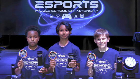 Adams Middle School’s Jayden Sampay, Adhrith Arun, and Hudson Gallen celebrate their Battle of the South Bay esports championship with trophies and lollipops.