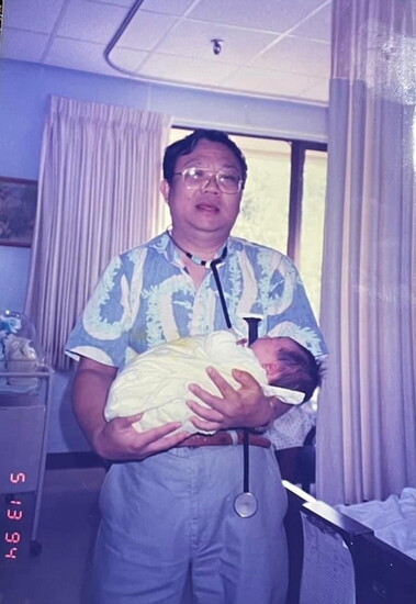 Dr. Sira and a baby he delivered in 1994