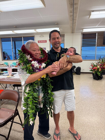 Dr. Sira (on the left) next to the youngest and oldest babies he has delivered