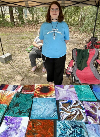 Young lady selling her artwork