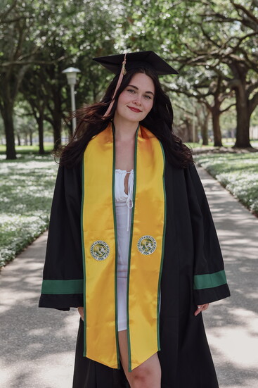 Natalie Blackburn celebrates graduation day in her cap and gown, supported by the VOTI Educational Grants Program. 