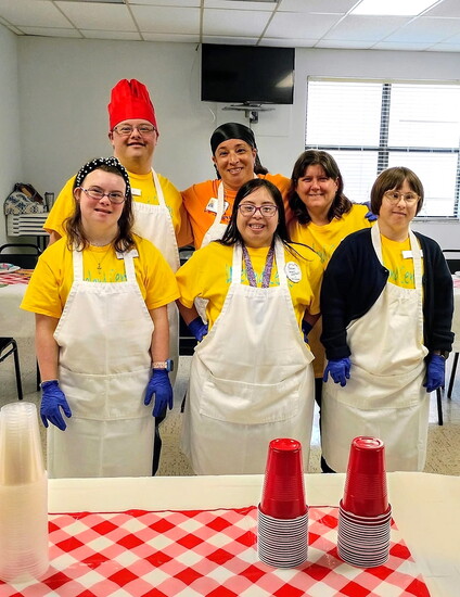 Loveland Center participants and staff don aprons and smiles, celebrating inclusion and a cooler future—thanks to a $100K HVAC grant from the Selby Foundation.