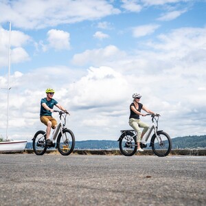 free-photo-of-a-couple-wearing-helmets-riding-electric-bikes-near-a-boat-300?v=1