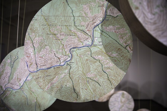 Drum-shaped, maps and photos create exhibit.
