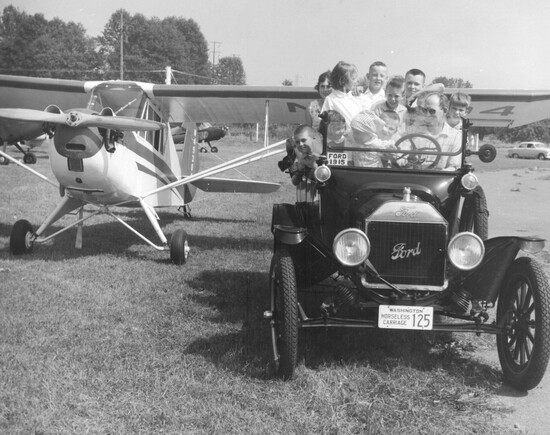 Ford car and Harvey Airfield airplane, 1955