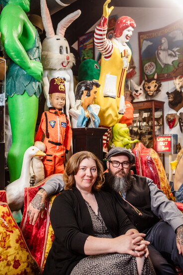 Jeremy and Kim Gibbs sit among some of the more colorful and whimsical items in the museum. 