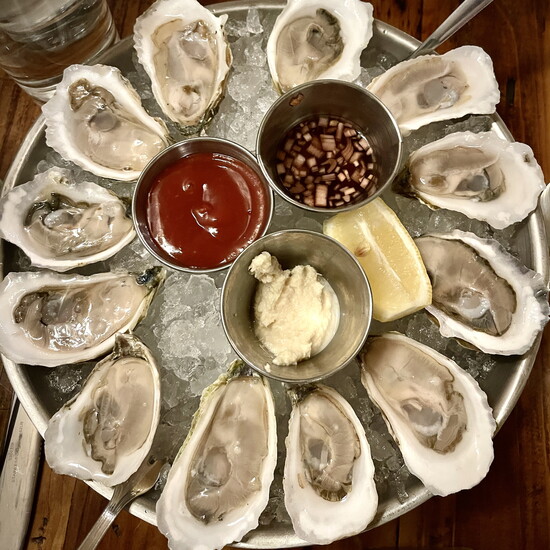 At Pearl Seafood & Raw Bar, an ice cold platter of Murder Point Oysters.