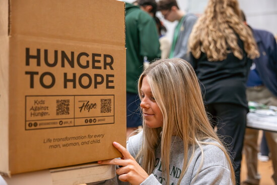 Upper school students pack donations for non-profit Mission of Hope.