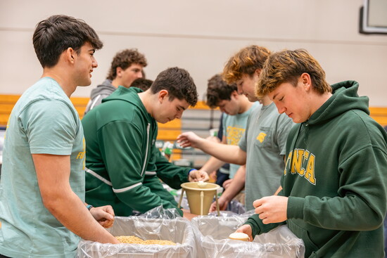 Students fill bags with rice as part of the Mission of Hope food packing.