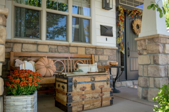 Cozy cushions add a perfect fall accent to this stunning porch.