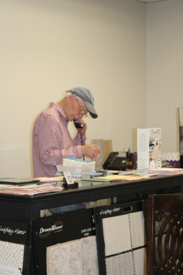 John Flack makes a call at Glover & Flack's Flooring Warehouse.