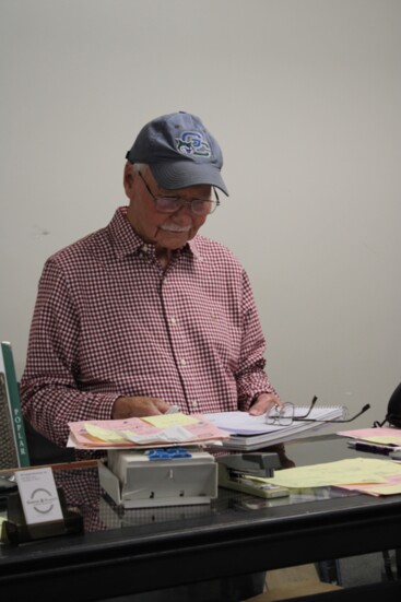 Joh Flack still handles paperwork on a busy day at Glover and Flack's Flooring Warehouse.