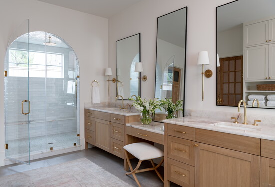 White oak cabinets and natural stone pair well in this bathroom by Williams House.