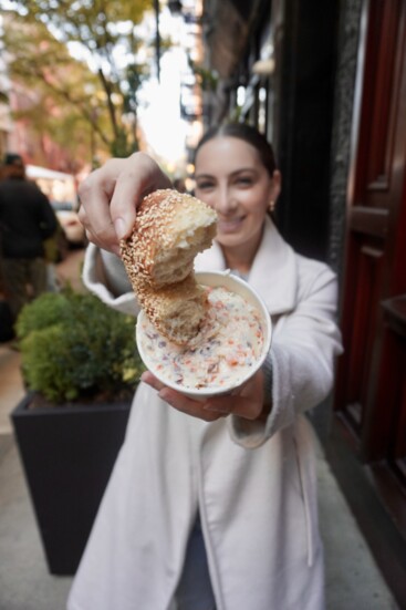 Carly with a bagel from PopUp Bagels.