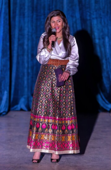 Aditi speaking at a Passport 2 Fashion runway show