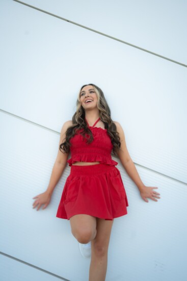 Clare sports a Modern Moves red-cropped halter top ($42) and pocket detail skirt ($52). Versatile for both strapless and halter styles.