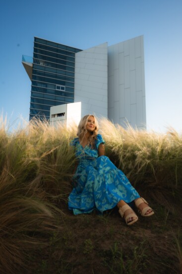 Get ready to float on a cloud of comfort and style with Pink Attitude Boutique’s If You’re Happy blue floral maxi-dress ($58) modeled by Megan Cox. 