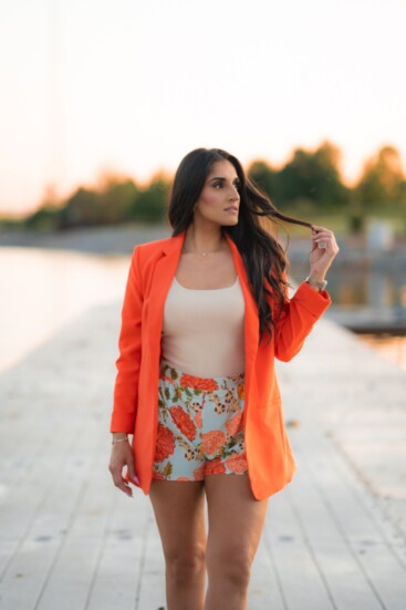 Basha Garner models Finest Hours’ orange summer blazer ($44), Heartbreak Away cream-ribbed tank top ($24) and Mandatory Motives’ mint floral print shorts ($36).