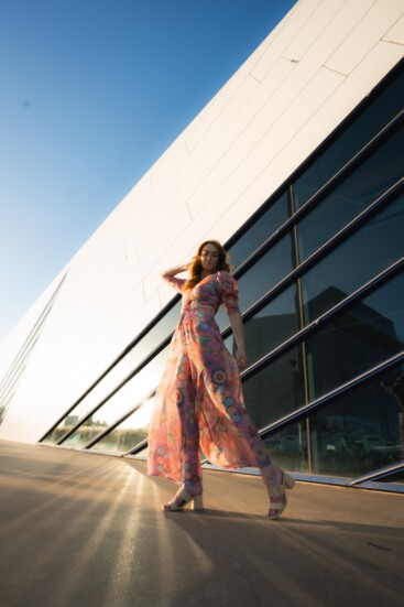 Maggie strikes a dramatic pose in a puff-pink top ($32) and pink print Pilazzo pants ($44), both by Unforgivable.