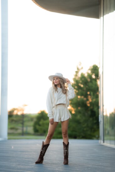 Megan gets ready for a wild ride this summer with Lasso Laps’ Western fringe cream summer two-piece set ($96). 