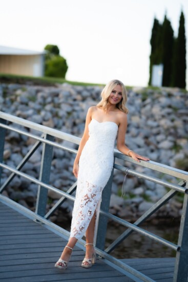 Megan looks elegant in Love Everlasting’s white strapless lace midi-dress ($102). 