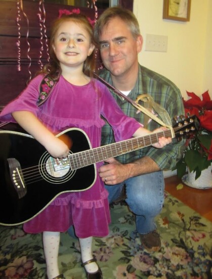 Carlotta and her father, Ed, with her first guitar on her 5th birthday.