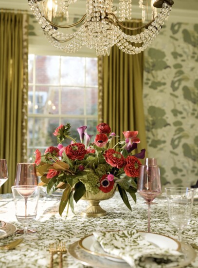 Holiday compote centerpiece with garden roses, anemones, ranunculus and calla lilies in seasonal colors plus bright green coxcomb for texture, kale and