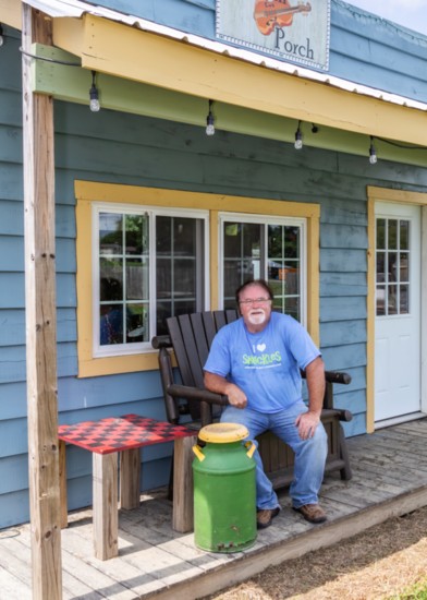 Fiddle Dee Farms co-owner Craig Pulley takes a break in front of the Pickin' Porch.