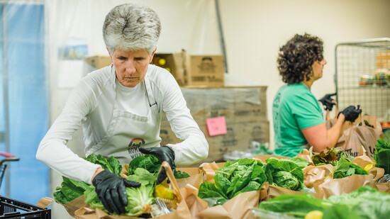 Looking through produce at Fishes and Loaves. Photo Credit: Sherer Joy Photography