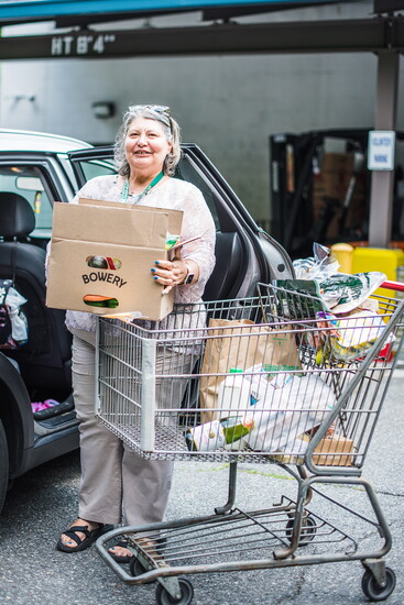 Individual unloading a cart from Loaves and Fishes. Photo Credit: Scherer Joy Photography. 