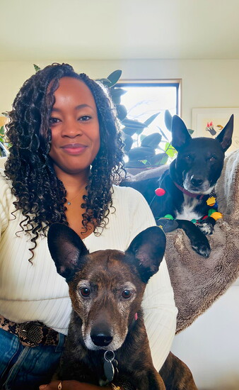 Noelle Scaggs enjoys a cozy moment at home with her beloved dogs, Marley and Hell-n.