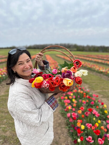 Laurie Mensing taking a quick bloom break among the tulips at Burnside Farms.