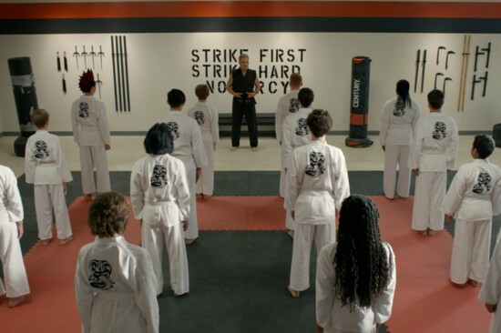 John Kreese and students at the Cobra Kai Dojo