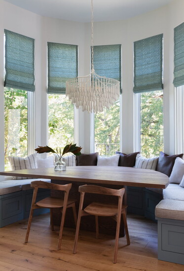 A cozy breakfast nook adorned with a charming chandelier, adding a touch of elegance.