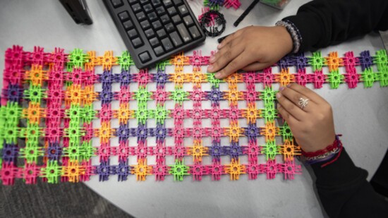 A colorful grid stretches across a student's desk as she works on a project at the Bella Romero Smartlab.