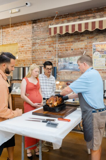 Brent Batton, partner with Freedom House Wash, and his wife, Alexandria, learned how to properly carve a turkey.