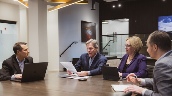 Senior Goelzer team members gather to discuss community engagement.