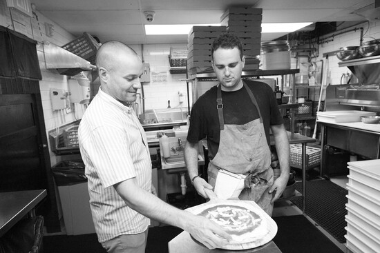 Massimo in the kitchen with his pizza dough. 
