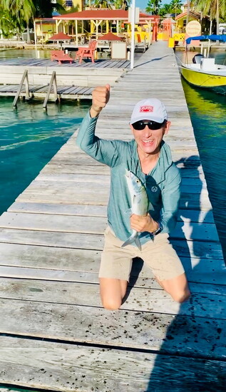 His first saltwater fish caught on a fly rod; Bone Fish in Belize