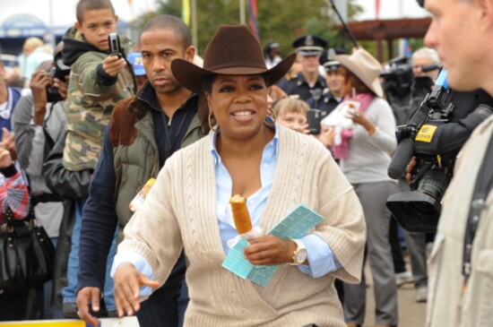 Oprah Winfrey samples a Corny Dog (Photography: The State Fair of Texas)