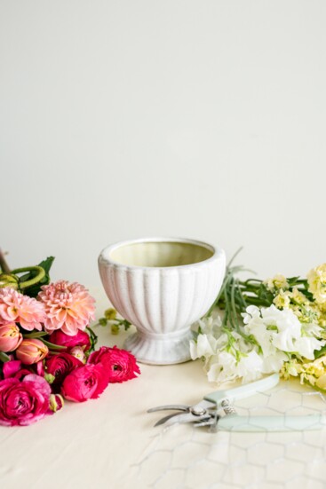 To build an arrangement with a more wild and natural shape, start with a container with a bit of depth.