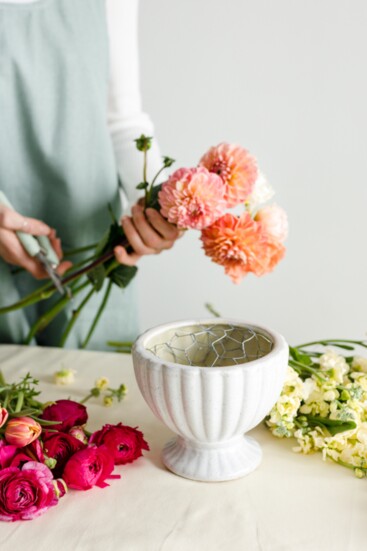 Cut a piece of chicken wire and form it into a ball so it will fit tightly into your floral bowl. Tape the chicken wire into the floral bowl with floral tape.