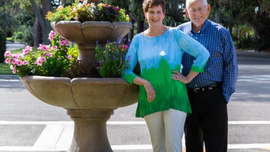 Bob and Susan Vedder by a flower fountain in Venice