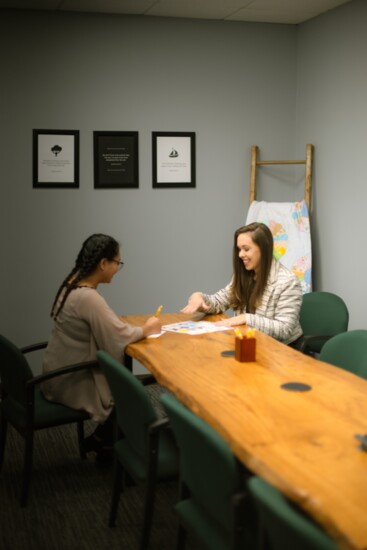Katie E. Brown speaks with a client in her office. 