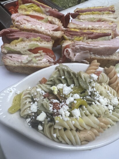 Italian double decker club sandwich with pasta salad 