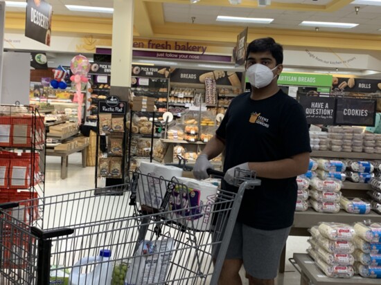 Dhruv Pai grocery shopping before making a delivery through the group he founded, Teens Helping Seniors.